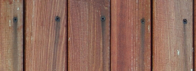 Close up of brown wooden fence panels. Many vertical wooden plan