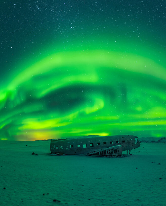 VISITING PLANE WRECKS UNDER THE NORTHERN LIGHTS